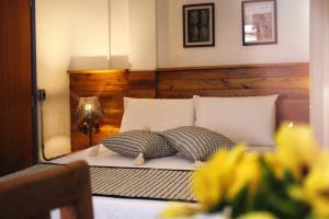 Ein Bett oder Betten in einem Zimmer der Unterkunft Pousada Caminhos de Minas Belo Horizonte