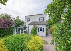 a white house with a gazebo in a yard at Private, 5-star vacation home on a beautiful island in De Cocksdorp