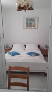 a bedroom with a bed with a ceiling fan and a mirror at Apartments Zdenka in Marina