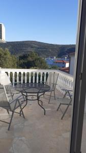 a table and chairs on a balcony with a view at Apartments Zdenka in Marina