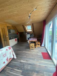una habitación con cocina y una mesa en una casa en Chalet cosy, belle vue, dans le massif du Vercors, en Lans-en-Vercors