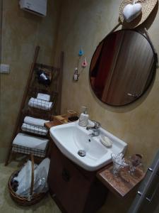 a bathroom with a sink and a mirror at Villa Gianna in Karpenisi