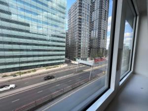a window with a view of a highway and buildings at Lovely apartment in the centre of Croydon in Croydon