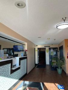 a lobby of a hotel with a reception desk at Super 8 by Wyndham Campbellsville KY in Campbellsville