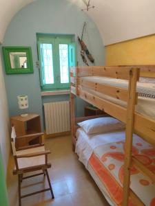 a bedroom with two bunk beds in a room at Il Trullo del Nonno a Cisternino in Cisternino