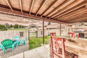 a patio with a table and chairs on a deck at Villa Con Vista with Putting Green and Hot Tub! in Ruidoso