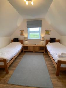 A bed or beds in a room at Quinag - luxury villa with sea views in Achiltibuie