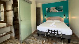 a small bedroom with a bed and a shower at Logis Hôtel Restaurant Bellevue in Saint-Martin-dʼArdèche