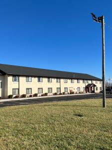 a large building on the side of a road at Super 8 by Wyndham Campbellsville KY in Campbellsville