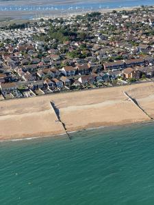 an aerial view of a beach with houses and the water at The Beach House in South Hayling