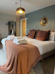 a bedroom with a large bed with a blanket on it at Lindum Barn, Ashlin Farm Barns in Lincoln