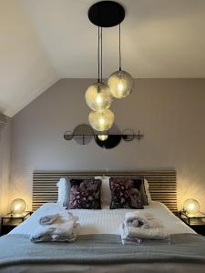 a bedroom with a bed with two towels on it at Lindum Barn, Ashlin Farm Barns in Lincoln