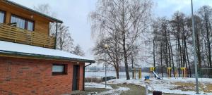 a playground in a park covered in snow at Poilsio bazė Draugai in Daugai