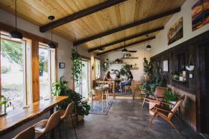 two people sitting at a table in a room with plants at Ninepipes Lodge in Polson