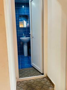 a bathroom with a shower and a sink at Travel Inn House Mestia • მოგზაურის სახლი in Mestia