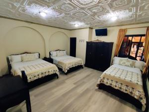 Giường trong phòng chung tại Hotel Vieja Mansion