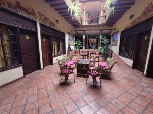 an empty patio with tables and chairs in a building at Hotel Vieja Mansion in Cuenca