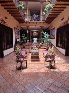 a courtyard with benches in a building at Hotel Vieja Mansion in Cuenca