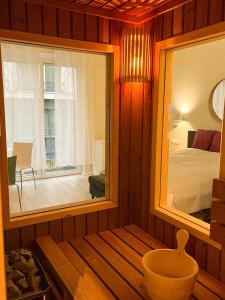 a room with a mirror and a bedroom with a bed at Studio at Synagogue with Sauna in Budapest