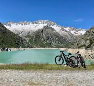 a motorcycle parked in front of a mountain lake at Casa Restelli OG - nahe Andermatt Gotthard in Gurtnellen