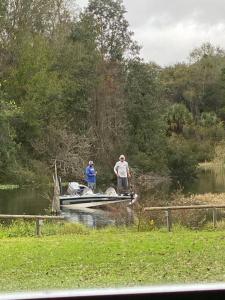two men standing on a boat in the water at Professor Rousseau's Fishing RV Retreat in Crystal River
