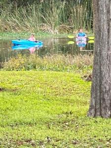 two people are in boats in the water at Professor Rousseau's Fishing RV Retreat in Crystal River
