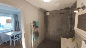 a bathroom with a shower and a sink at SCHWEIZER Hof in Tamsweg +42 photos