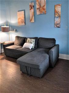 a couch and a ottoman in a living room at Niagara Getaway in Niagara Falls