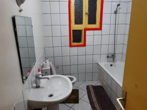 a bathroom with a sink and a tub and a mirror at Zitouna Rooms in Casablanca