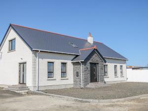 a white house with a black roof at SJs Cottage in Coleraine