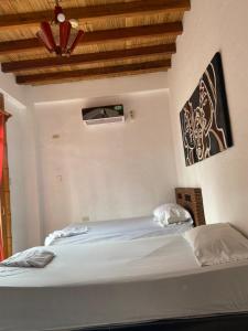 Postel nebo postele na pokoji v ubytování Hotel Karukera