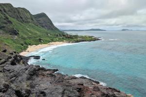 a view of a beach with rocks and the ocean at Apartments at Palms Waikiki in Honolulu