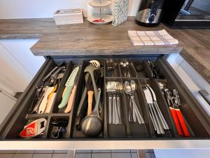 a drawer filled with knives and utensils in a kitchen at A&D Apartment+Ferienwohnung/Elsasser Blick in Bühlertal