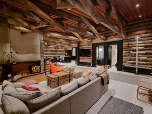 a large living room with a large couch and chairs at Arctic Villas Ruka in Kuusamo