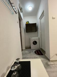 a small bathroom with a washing machine in a room at City center - Unirii studio in Bucharest