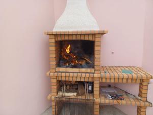 a brick oven with a fire inside of it at Casa da Ribeira - Mosteiros in Mosteiros