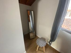 a chair sitting in a room with a window at Casa da Ribeira - Mosteiros in Mosteiros