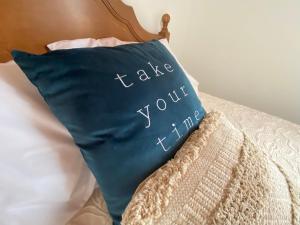 a blue pillow with the words take your turn at Casa da Ribeira - Mosteiros in Mosteiros