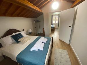 a bedroom with a bed with towels on it at Casa da Ribeira - Mosteiros in Mosteiros