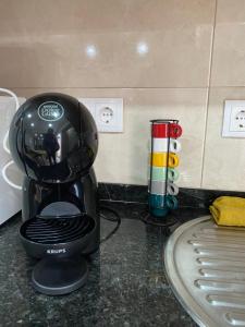 a black coffee maker sitting on top of a counter at Casa da Ribeira - Mosteiros in Mosteiros
