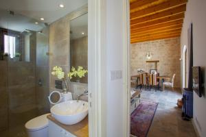 a bathroom with a sink and a toilet in a room at Mesogi Cottage in Mesoyi +26 photos
