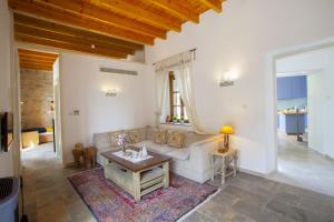 a living room with a couch and a table at Mesogi Cottage in Mesoyi
