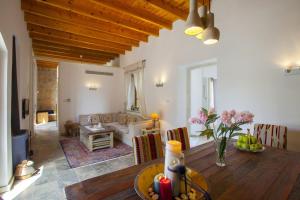 a dining room with a table and a living room at Mesogi Cottage in Mesoyi
