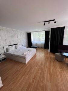 a large bedroom with a large bed and wooden floors at Escape Shumen in Shumen