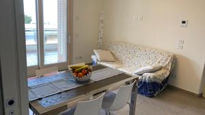 a living room with a table and a couch at Appartamento “Le vele” in Porto San Giorgio +13 photos