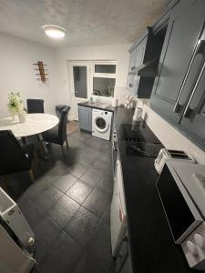 a kitchen with a table and a counter top at Hill View House in Newry