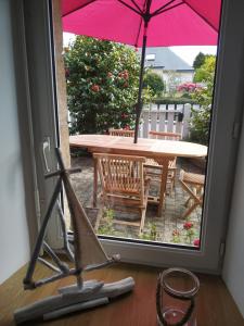 a view of a patio with a table with an umbrella at TI-ARMOR in Louannec