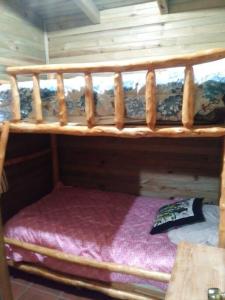a wooden bunk bed in a room with at Chalet in the Woods in Santiago Atitlán