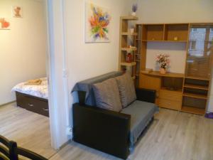 a living room with a chair and a bedroom at Romanilor - Studio First Floor in Deva