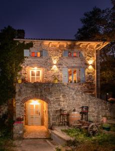 a stone house at night with lights on it at Villa Kotli Stone House in Kotli